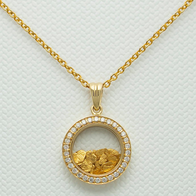 Close up image of 18 carat gold pendant with natural gold encased in strengthened glass